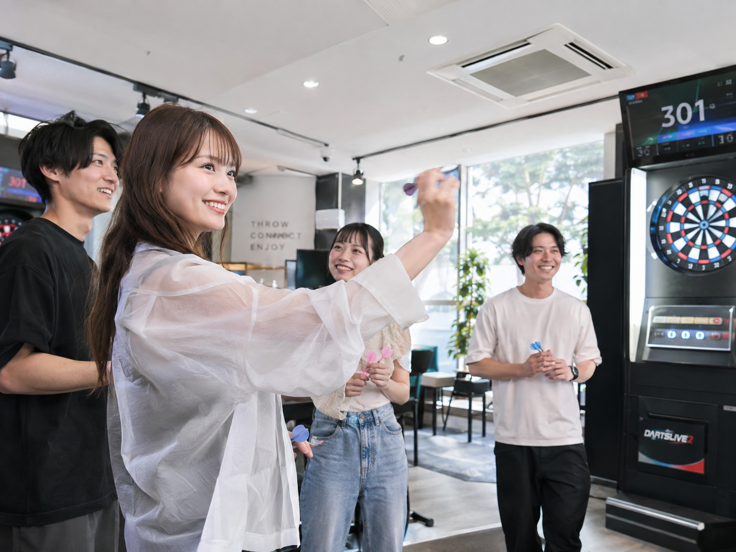 ダーツを楽しむ人々とダーツマシン